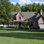 Pink house with a big green front yard